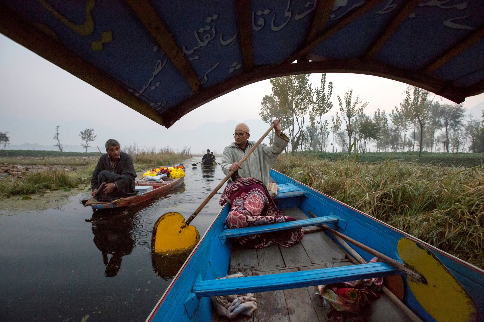 two-men-navigating-through-calm-waters-on-traditio